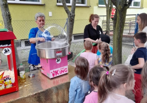 Pani Dyrektor kręci watę cukrową dla dzieci.