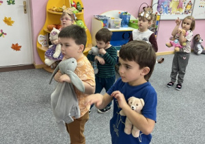 Chłopcy tańczą z misiami.