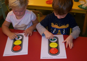 Laura i Nikodem malują malują farbami światła sygnalizatora.