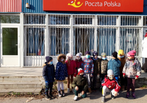 Dzieci przed budynkiem poczty.