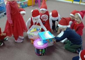 Dzieci rozpakowywują otrzymane prezenty.
