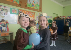 Amelka i Miłosz tańczą z balonem.