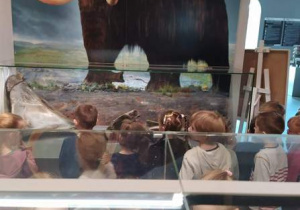 Dzieci oglądają zdjęcie mamuta.